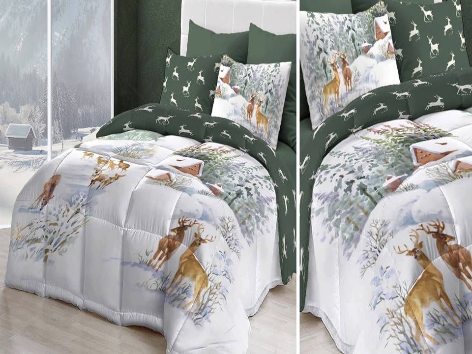 Un letto con un piumone e dei cuscini con sopra dei cervi.