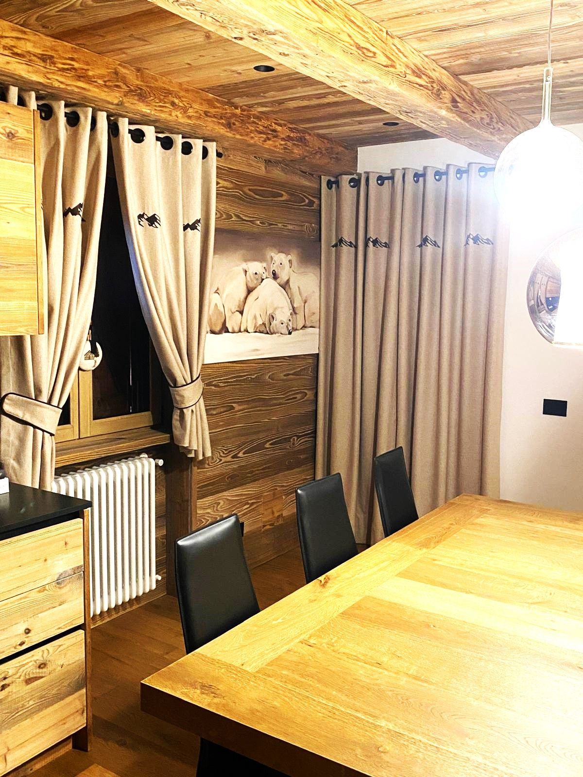 Una sala da pranzo con un grande tavolo in legno e sedie