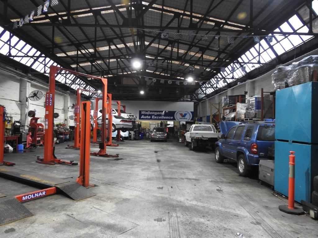 A Garage With Multiple Car and Car Lift — Wollongong Auto Excellence In Wollongong, NSW