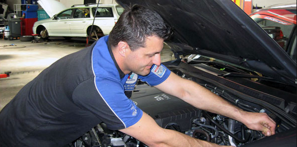 A Man is Working on the Engine of a Car — Wollongong Auto Excellence In Wollongong, NSW