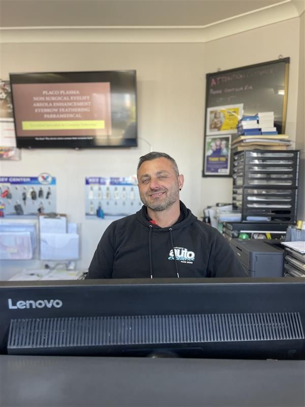 A Man is standing  behind a counter — Wollongong Auto Excellence In Wollongong, NSW