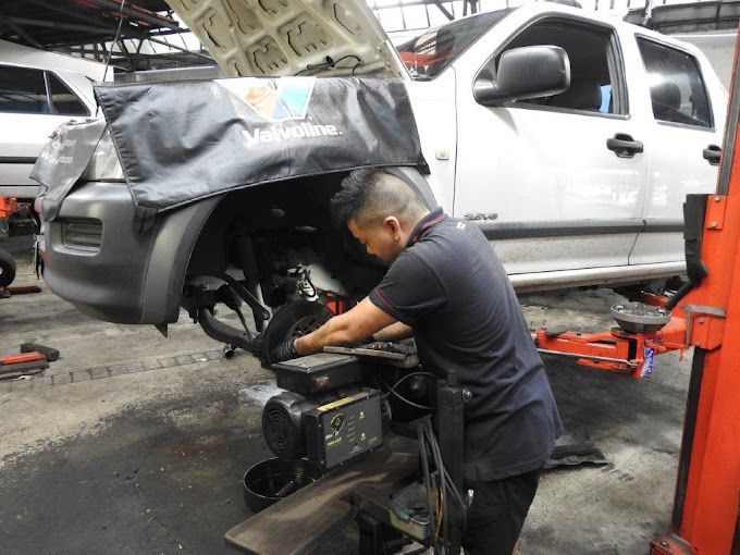 A Person is Fixing a Brake Disc on a Car — Wollongong Auto Excellence In Wollongong, NSW