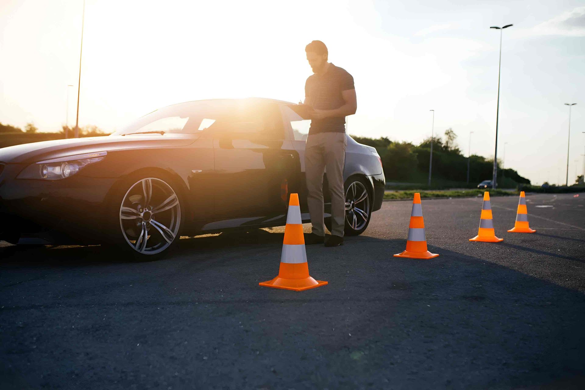 a Man is Standing Next to a Car in a Parking Lot — Casino Driving School In Casino, NSW