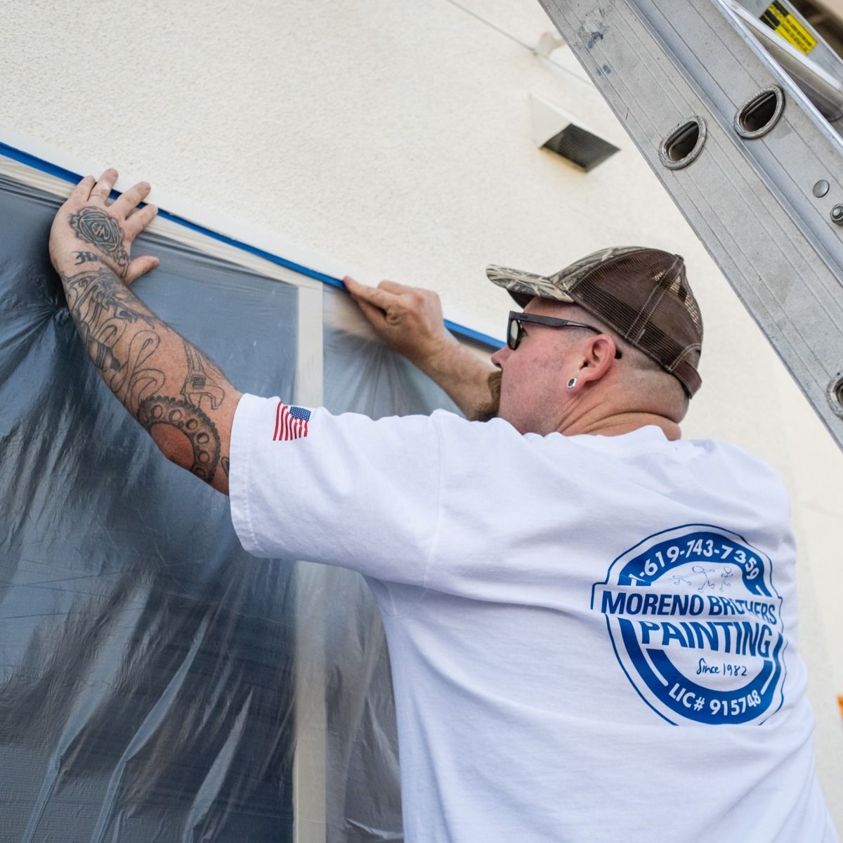 A man wearing a shirt that says moreno painting