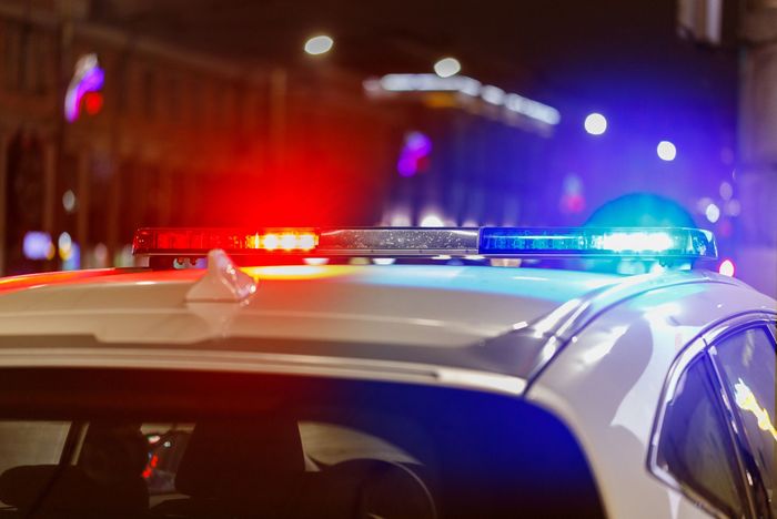 The roof of a police car is lit up at night