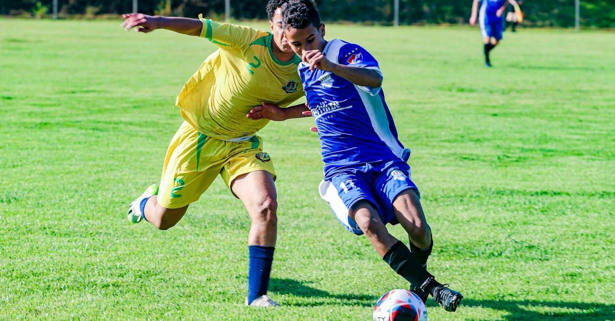 2 players tackling each other in a game of football