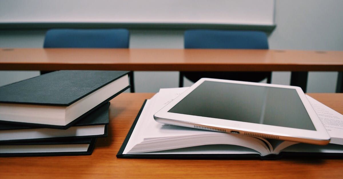 Books and a tablet laid on a school desk