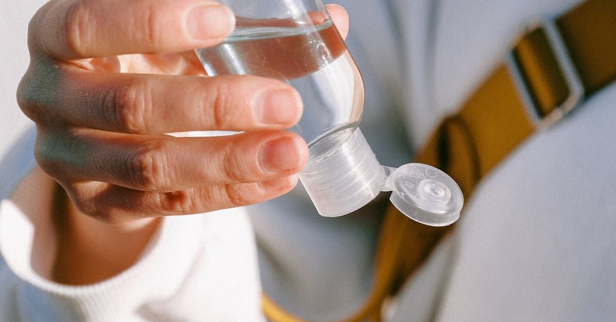 Person squeezing plastic bottle full of liquid
