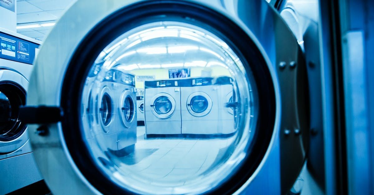 Picture of a laundrette taken through the door of a washing machine