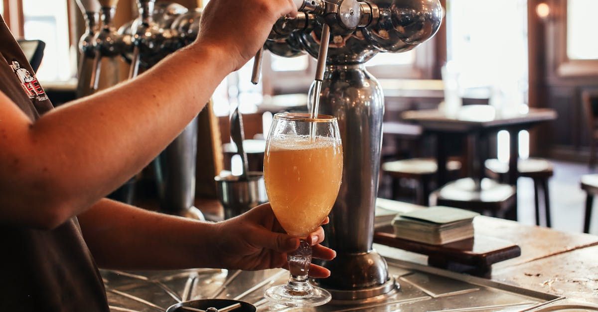 Person pulling a pint in a bar