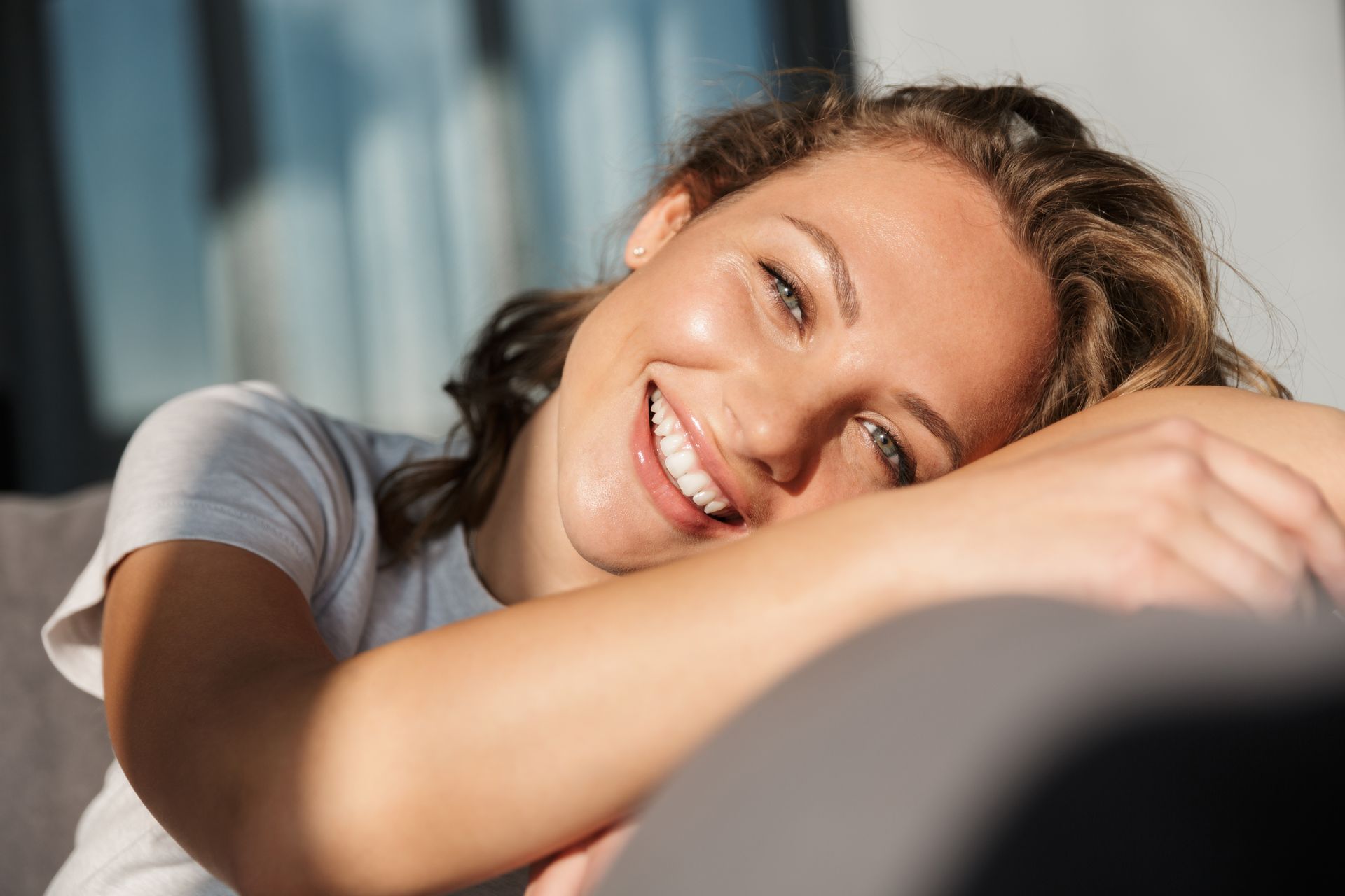woman smiling at home on couch