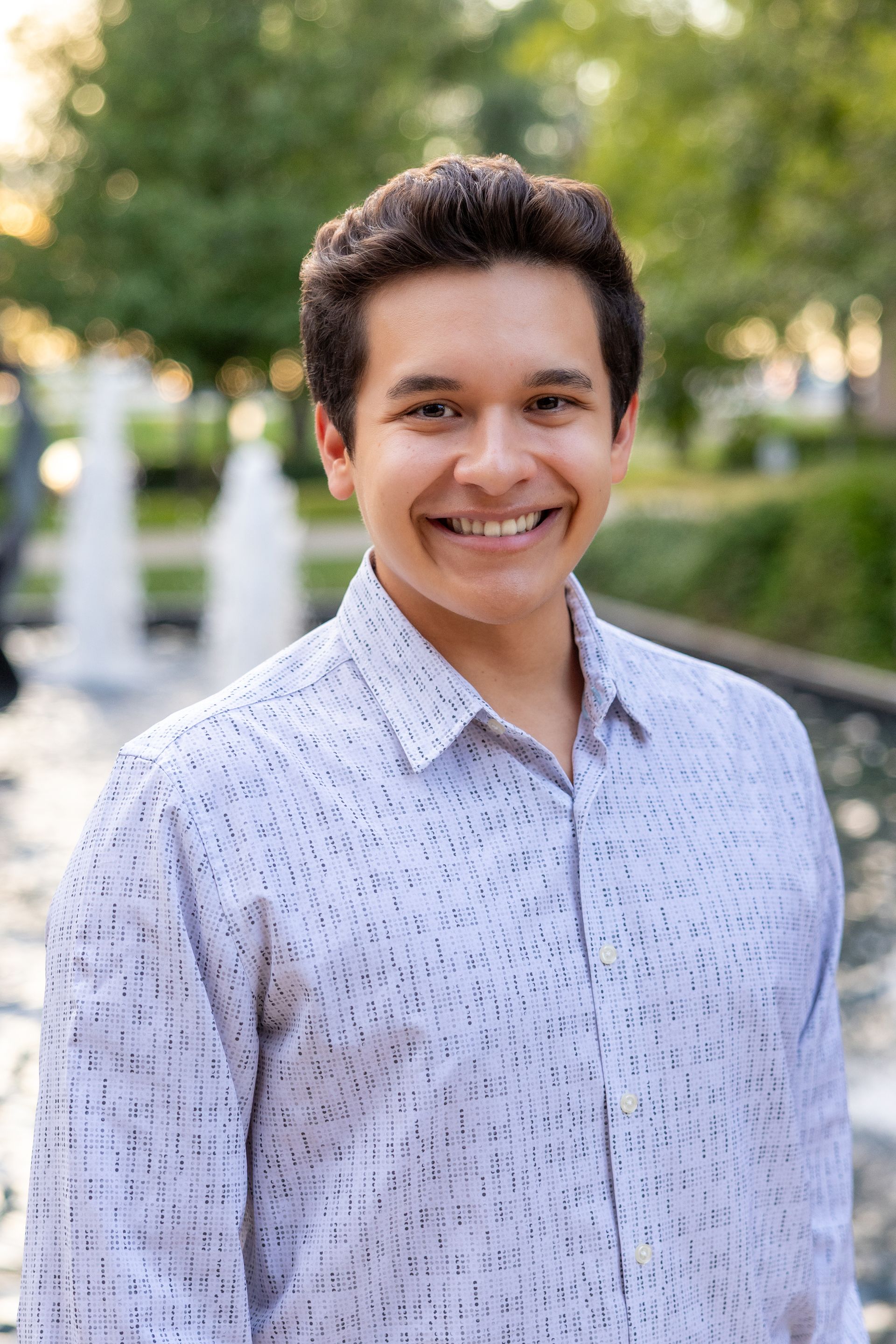 A man in a suit and tie is smiling for the camera.