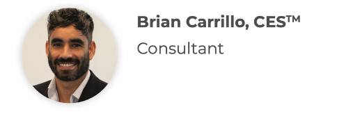 Brian Carrillo, smiling, dark hair and beard, wearing a suit jacket.