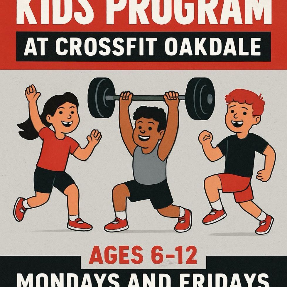 Woman coaching a young girl at a CrossFit gym, teaching her dumbbell exercises.
