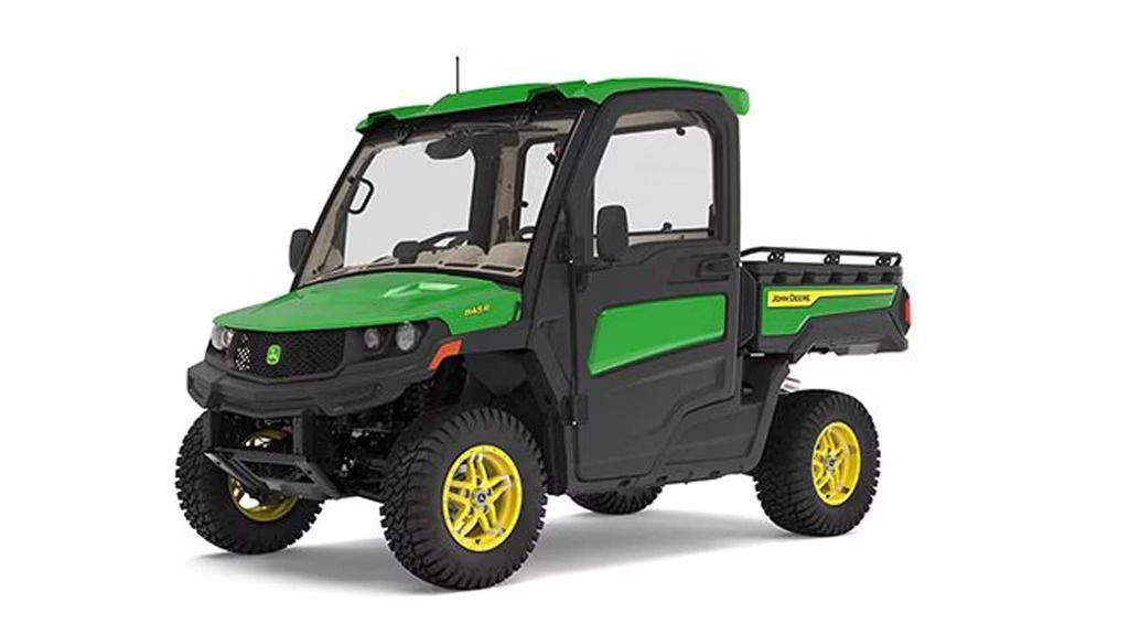John Deere Gator utility vehicle, green and black, with cab and cargo bed, on a white background.