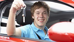 A man showing a car key being inside the car