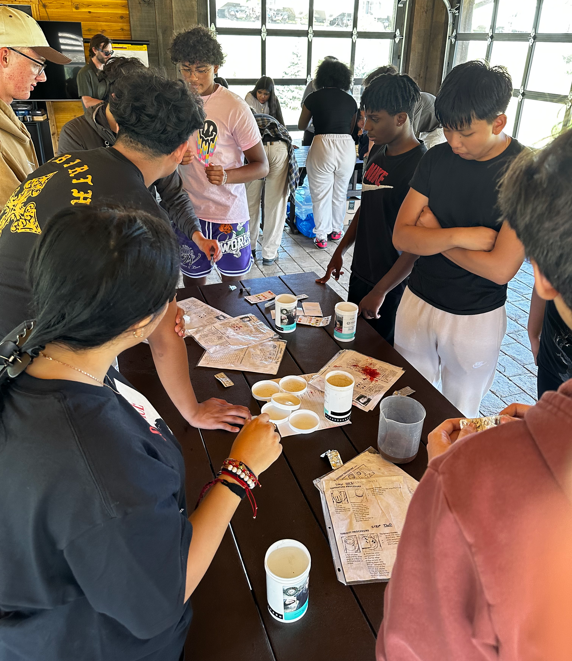 A group of children are sitting in a circle in the grass