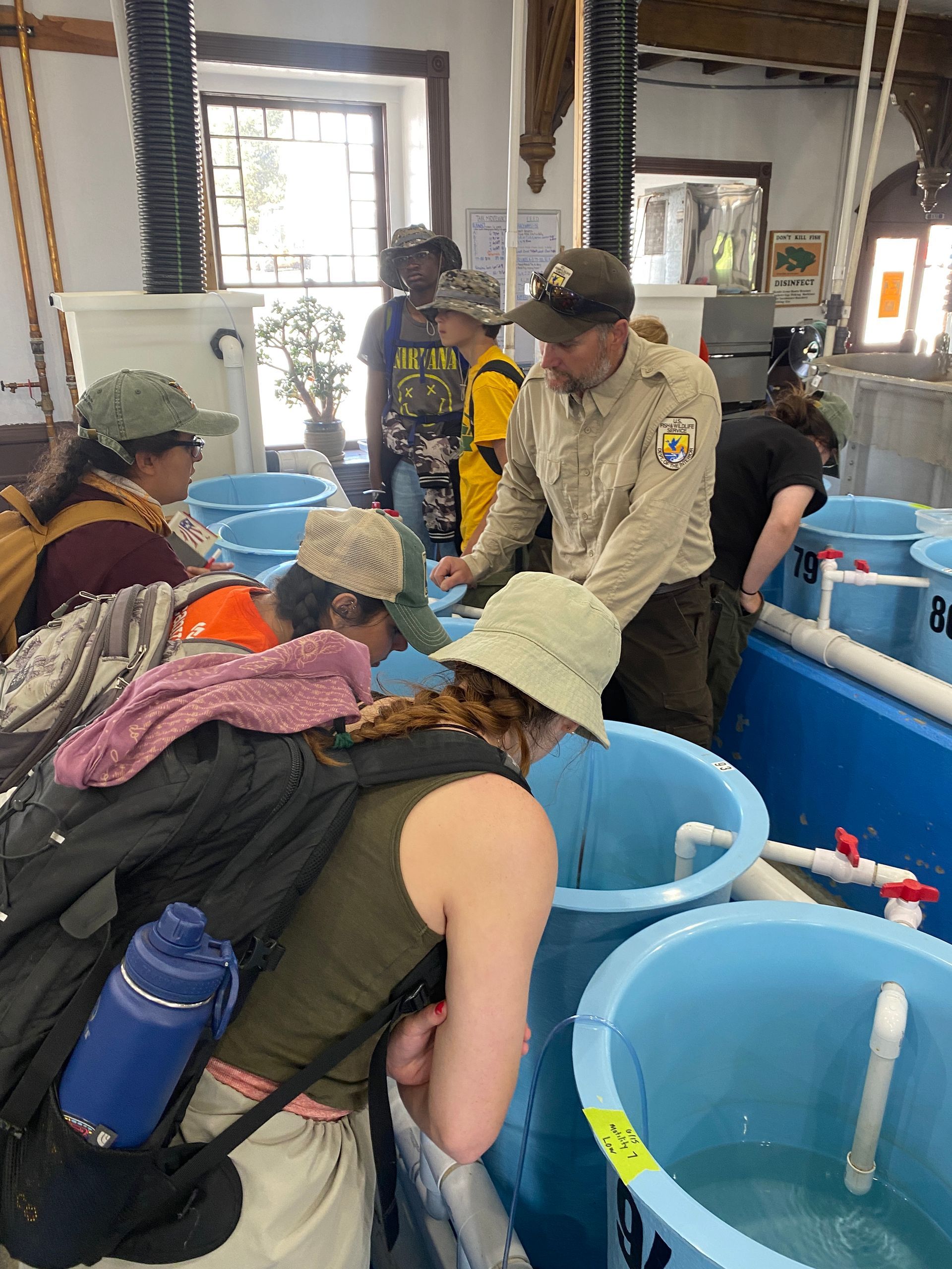 A man and a woman are fishing in a lake and giving each other a high five.