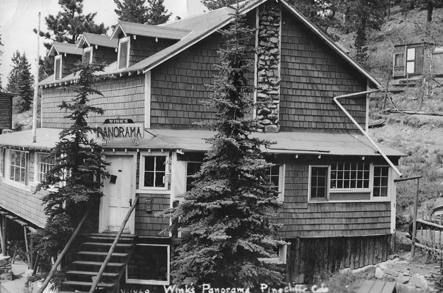 A black and white photo of a house that says panoramic