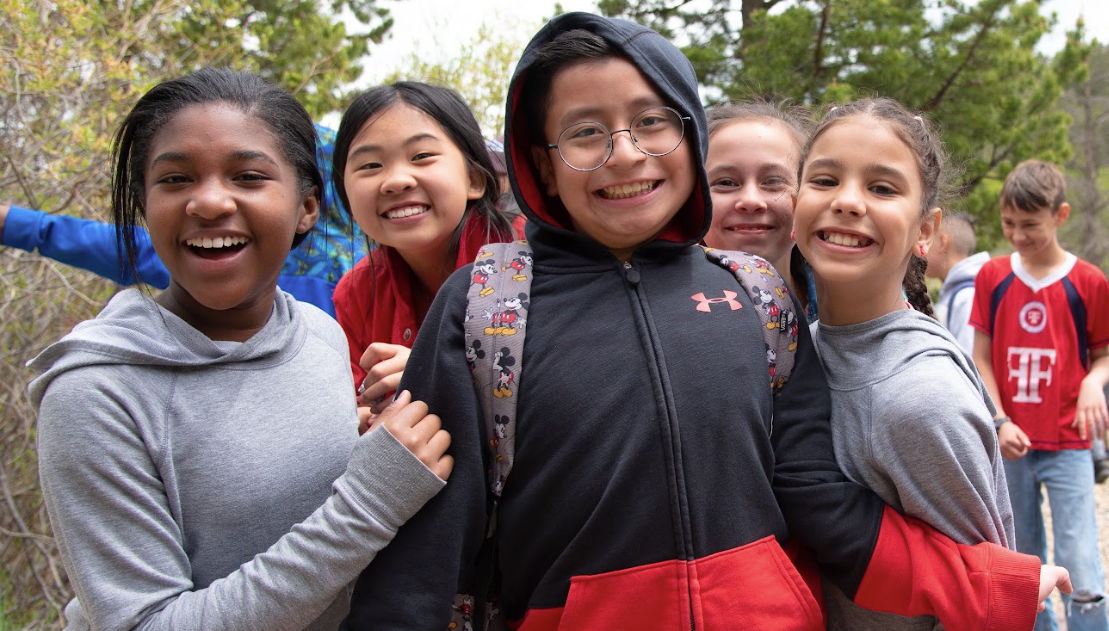 A group of young girls are posing for a picture together.