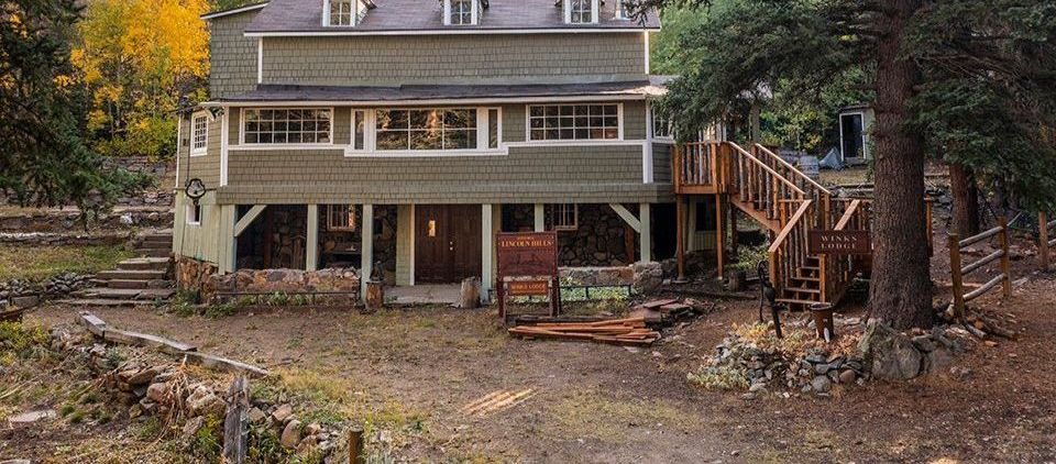 Two men are rowing a raft down a river.