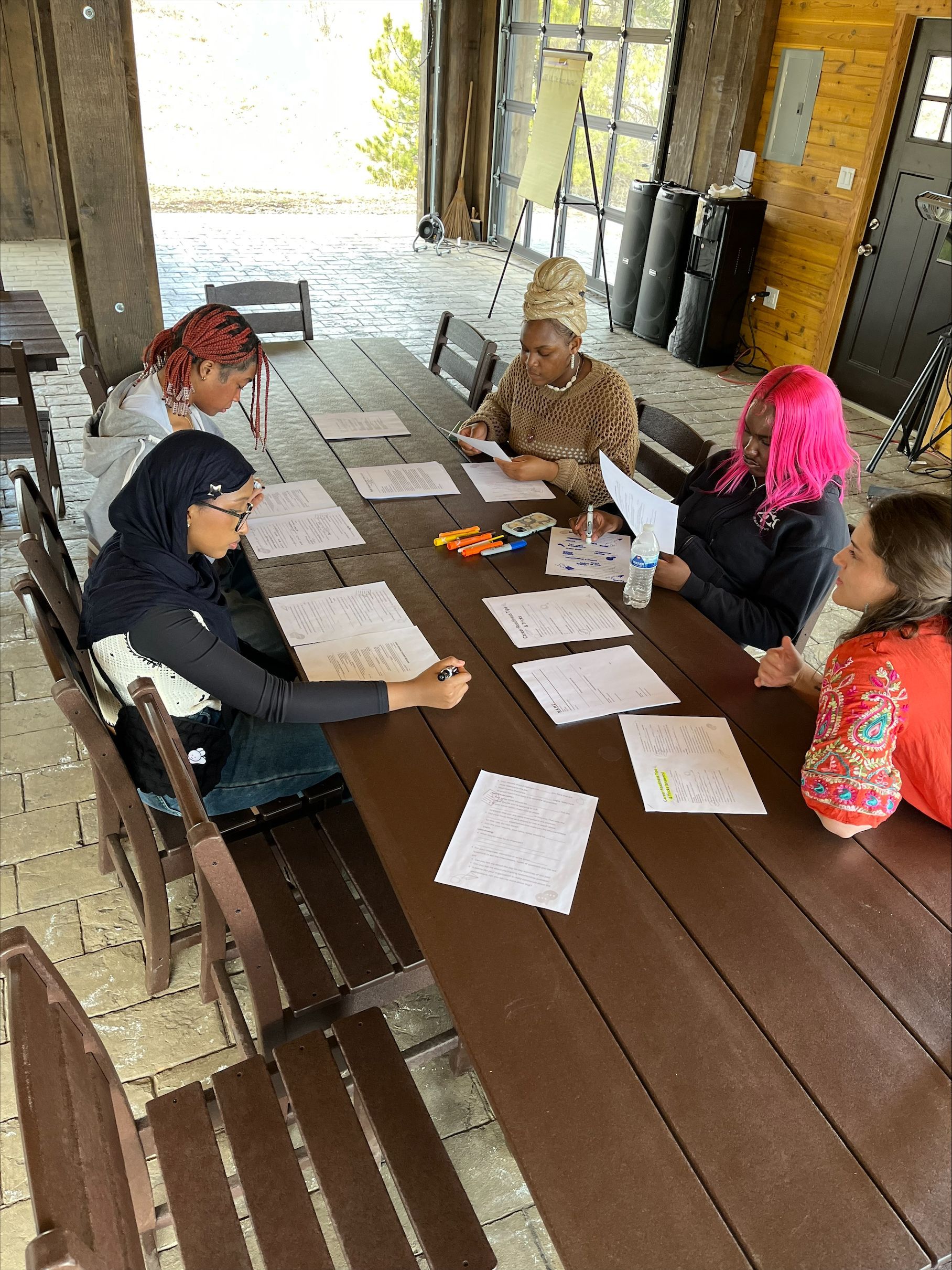 A young boy wearing a red hat and a blue shirt is holding a net.
