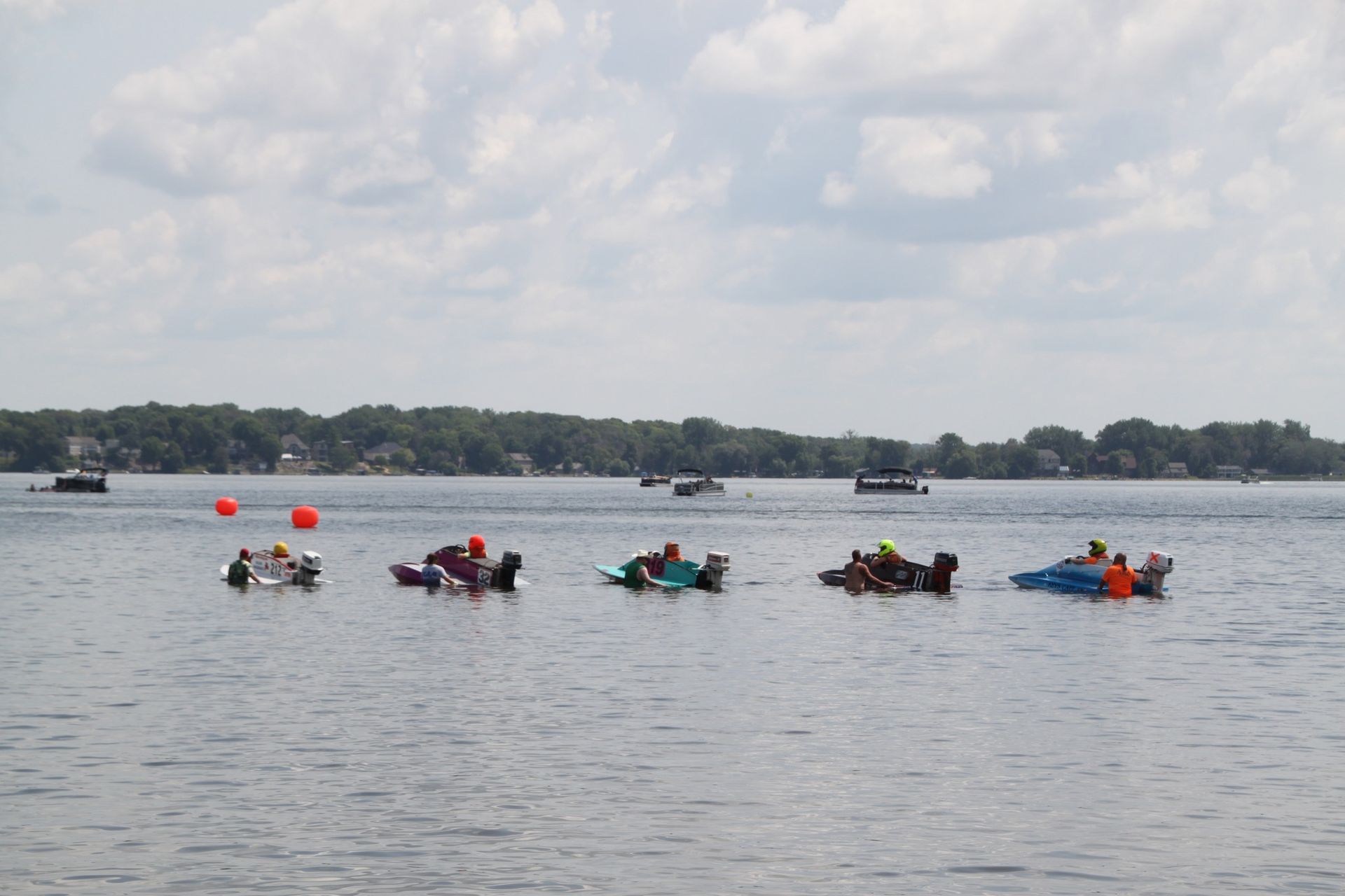 A group of people are rowing boats on a lake.