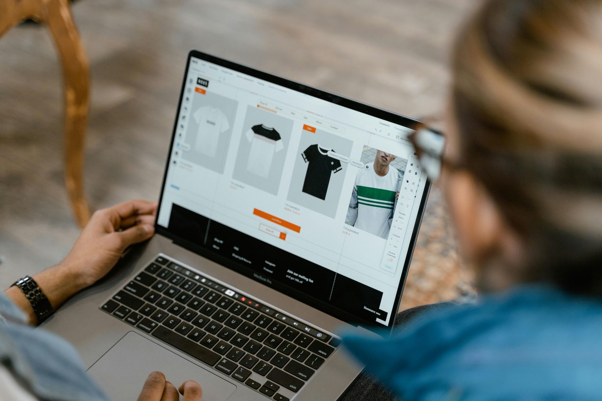 Person looking at a laptop doing a web design for clothing store — Twiss Digital Marketing in Caldwell, ID