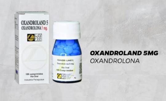 Caja y frasco de pastillas Oxandroland de 5 mg. Blancas y azules con texto negro y el logotipo de la marca.