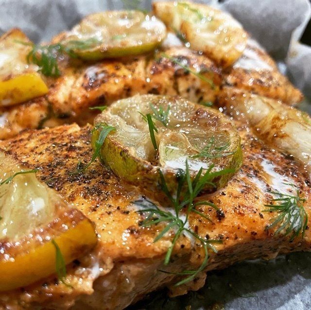 Fried chicken pieces in a foil container. Golden-brown, crispy skin.