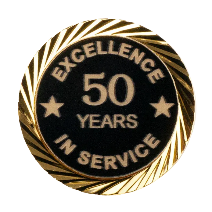 Gold and black pin celebrating 50 years of service. Text: