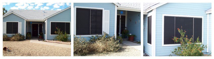 Blue house with black window screens. Dry landscaping in front.
