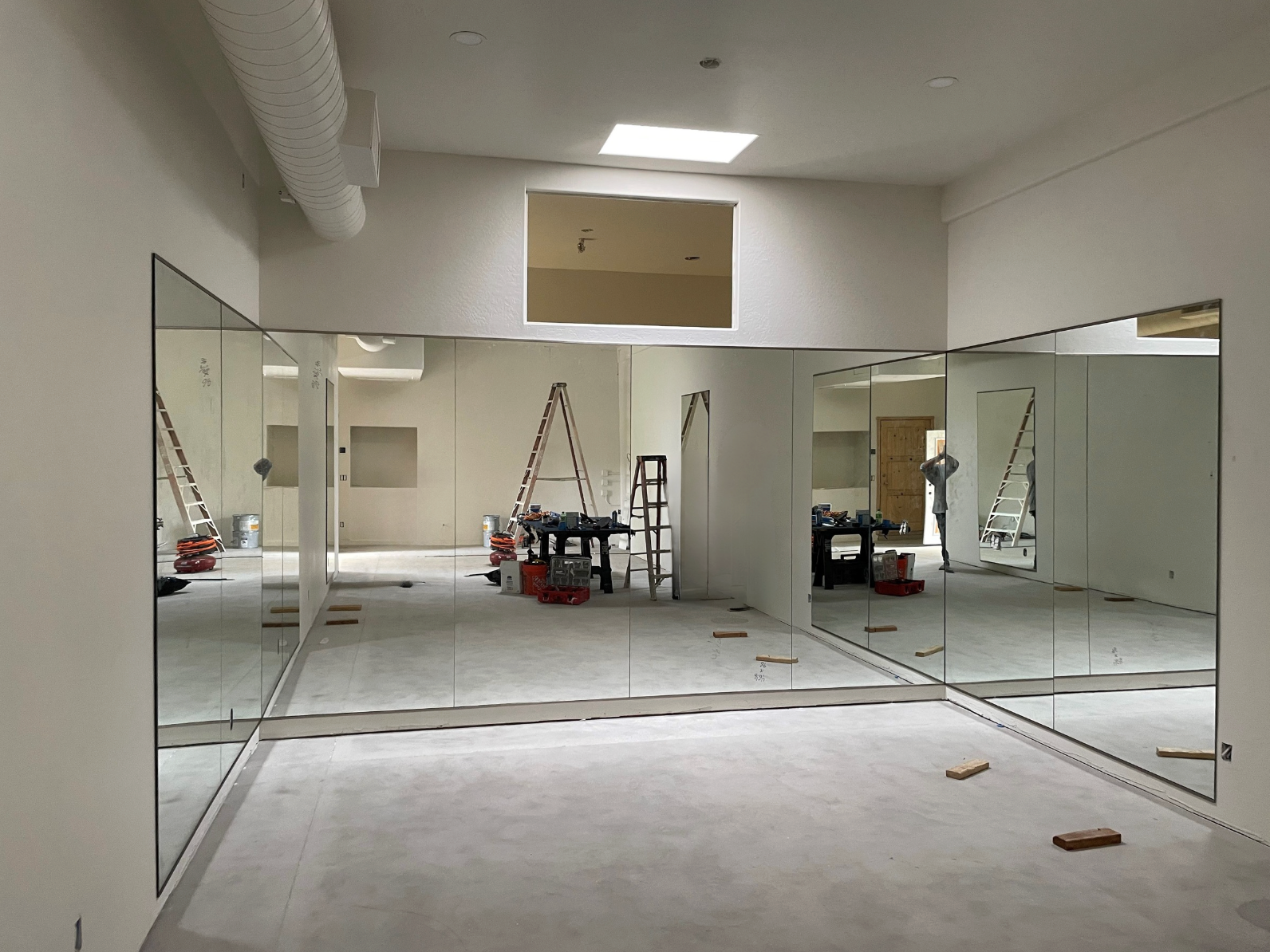 Large mirrors installed on the walls of a dance studio.