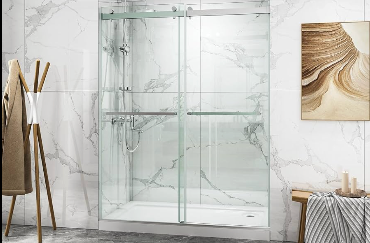 Glass shower enclosure in a bathroom with marble-look walls and a towel rack.