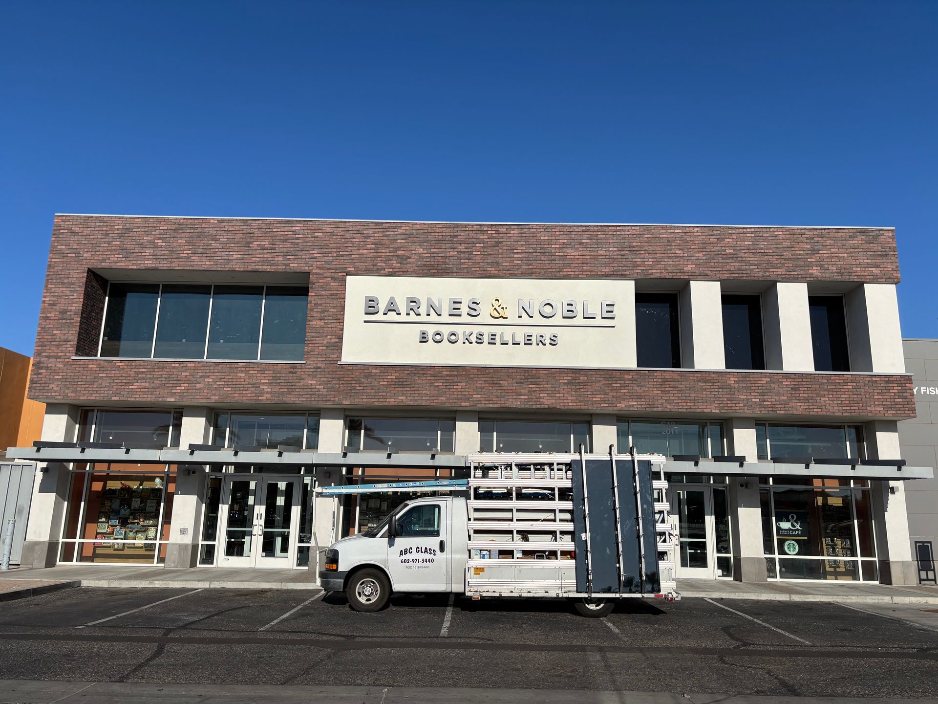 Barnes & Noble bookstore with a white truck parked in front under a clear blue sky.