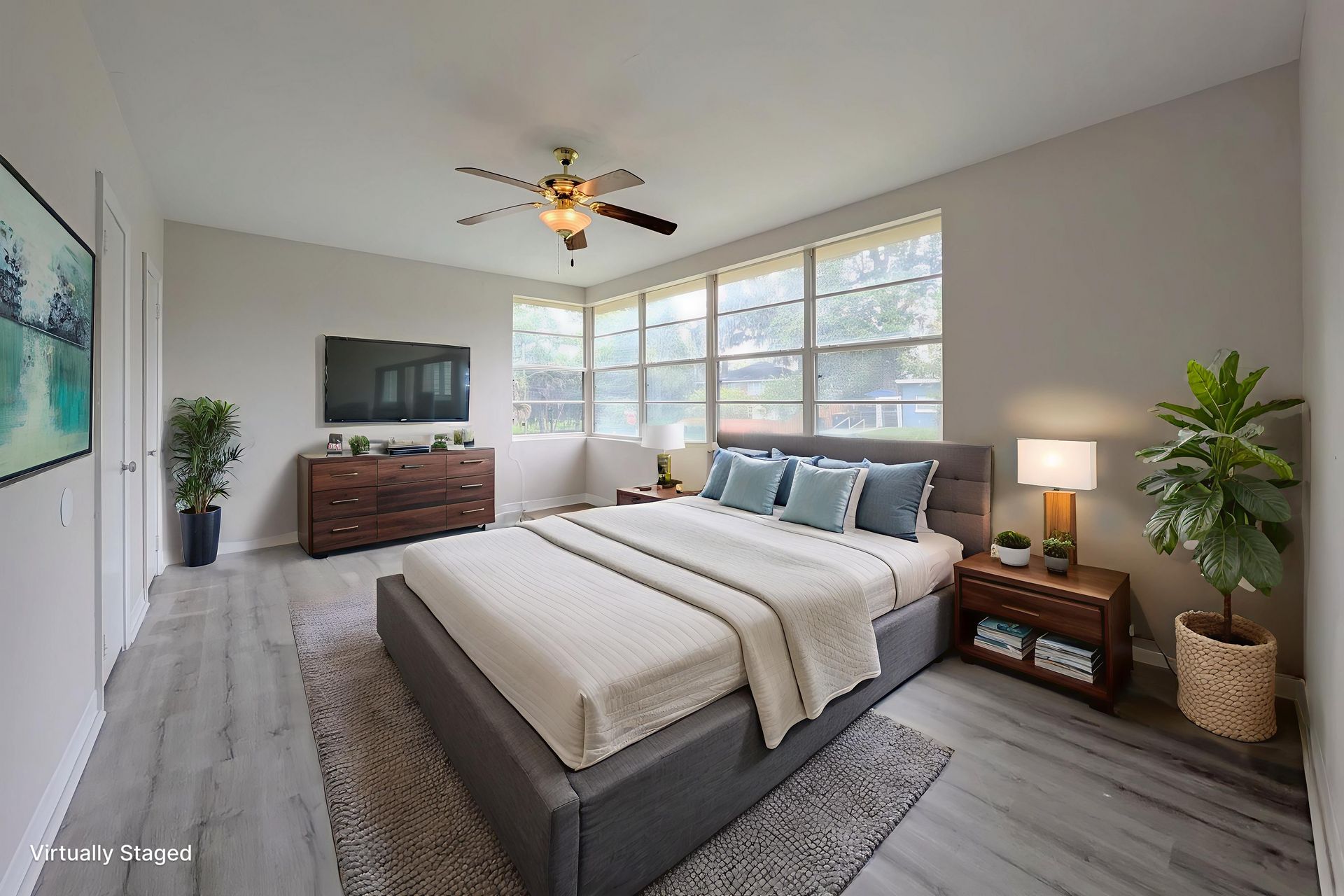 Bedroom with a bed, dresser, TV, and plants. Light grey walls, wooden furniture, and a window.