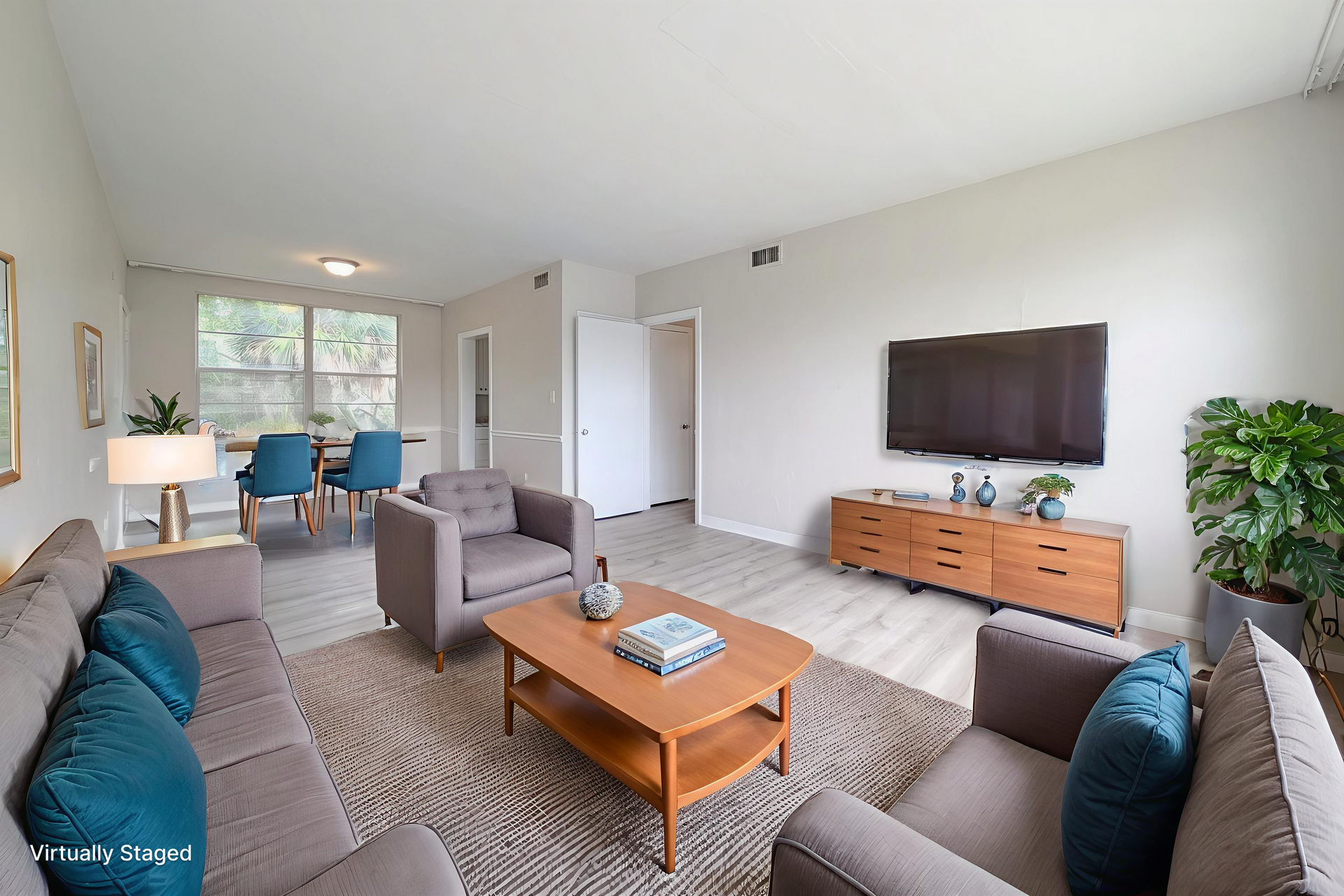 Bedroom with bed, bathroom door open, closet, neutral colors, decor.