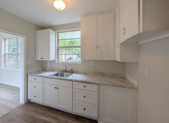 Kitchen with white cabinets, stainless steel appliances, and granite countertops.
