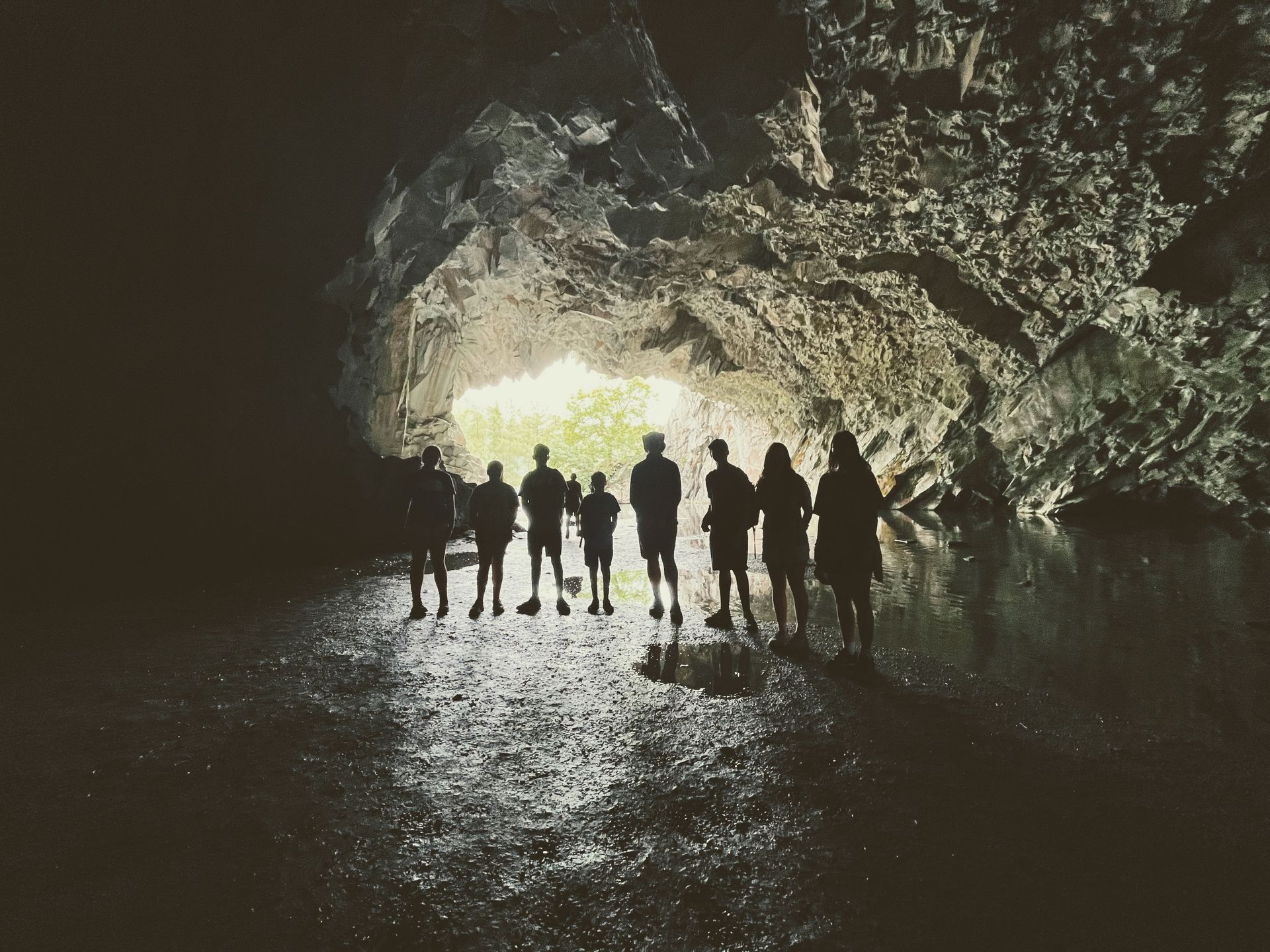 A group of people standing in a dark cave