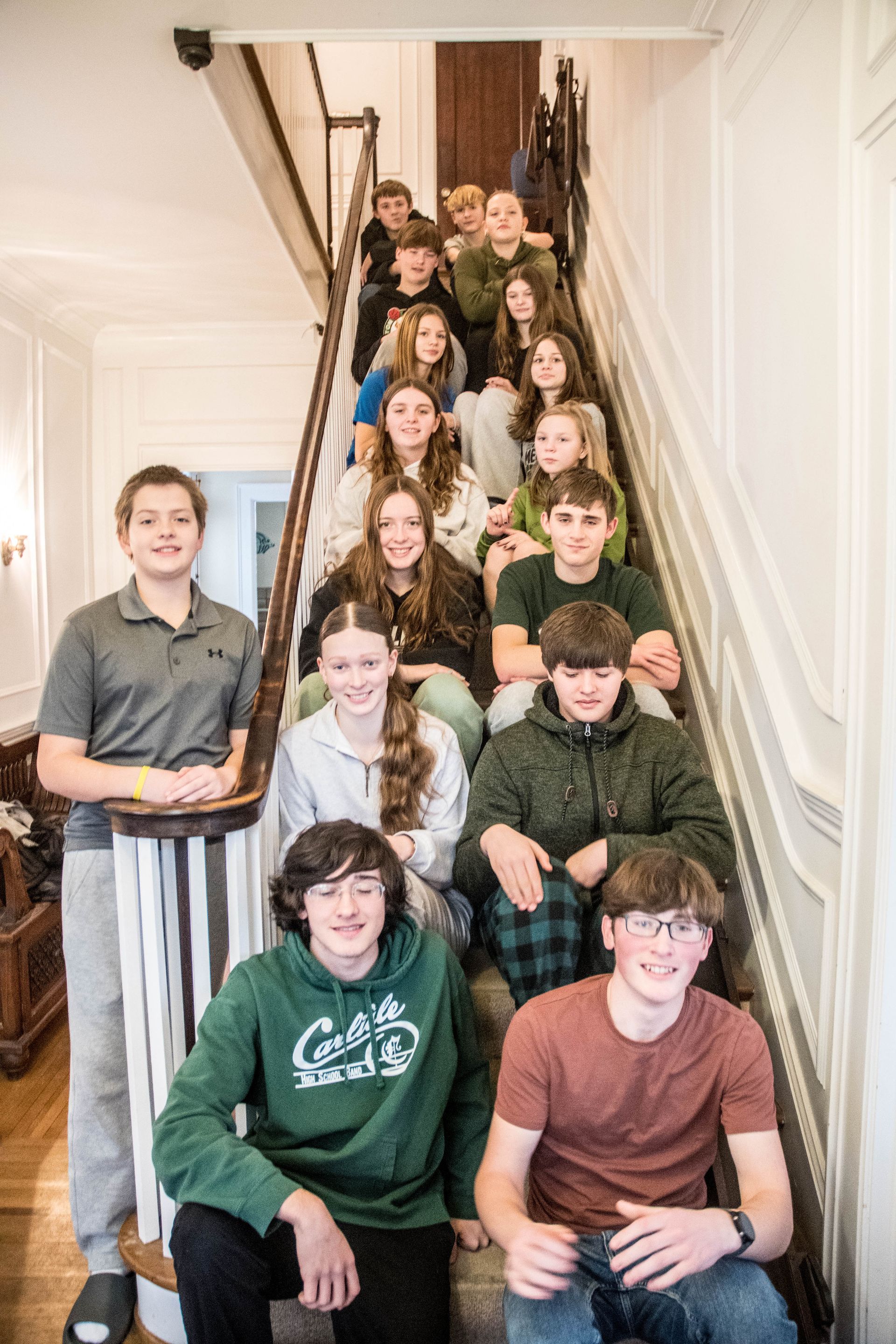 A group of young people are posing for a picture on a set of stairs