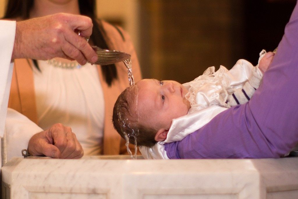 A baby is being baptised in a church