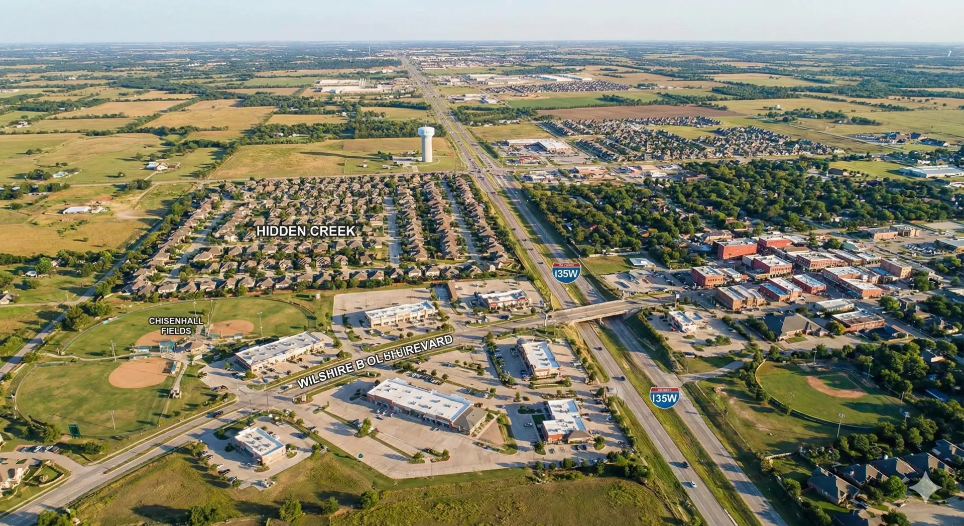 An aerial view of a city with a lake in the background.
