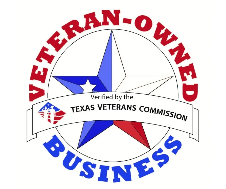 A row of dumpsters are parked in a gravel lot.