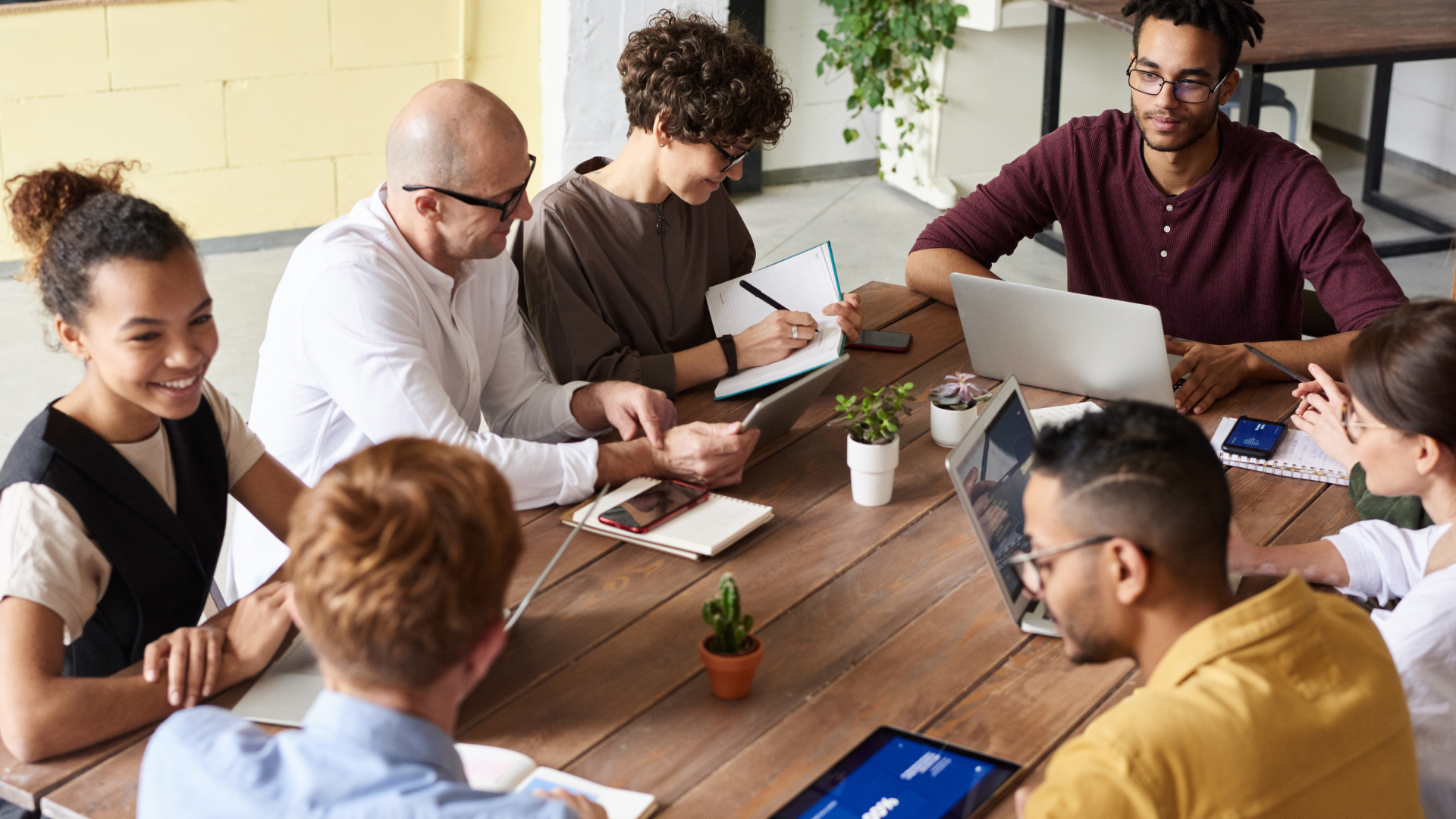 Image of a diverse, motivated team collaborating in a modern office setting.