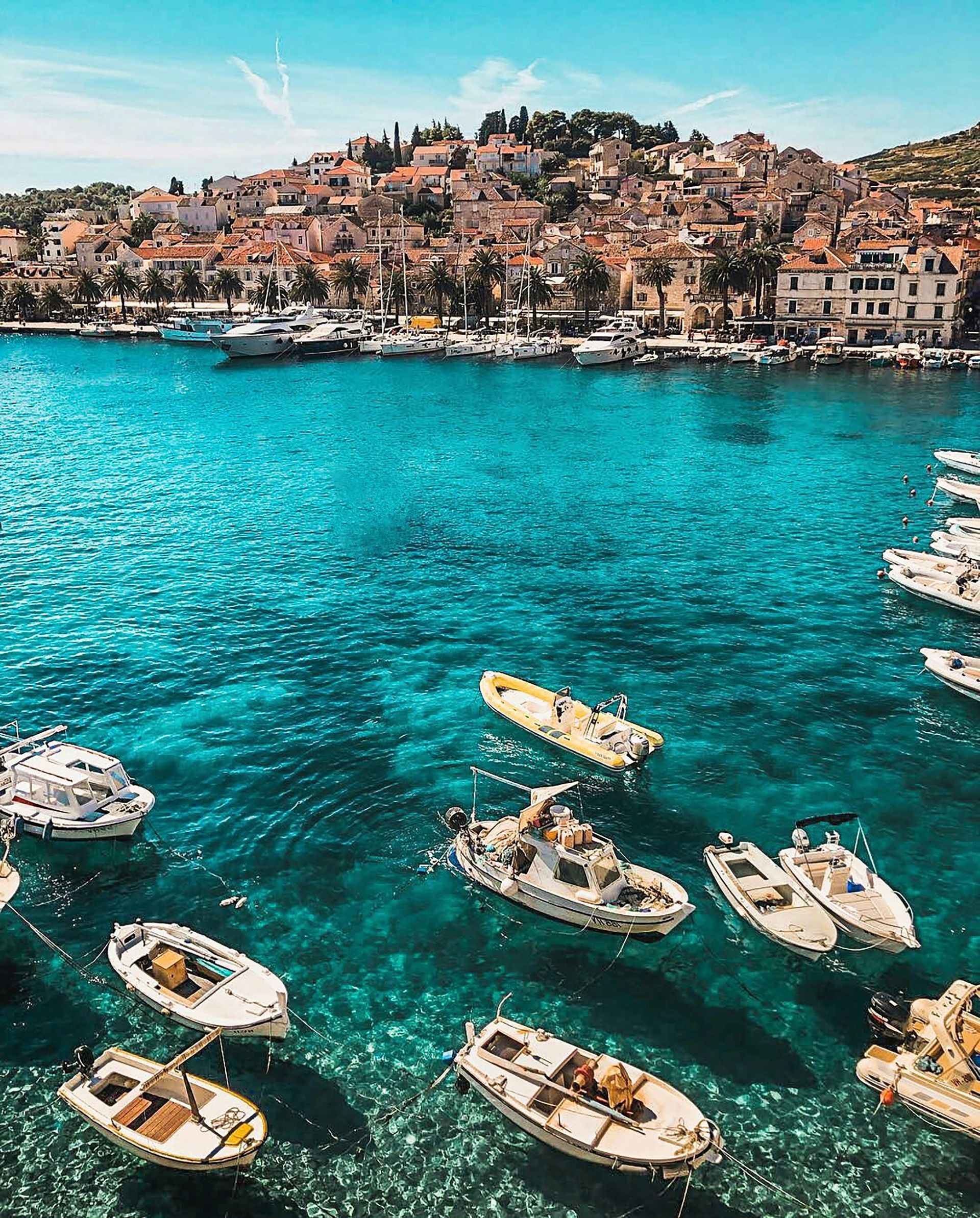 A group of boats are floating on top of a body of water in Greece