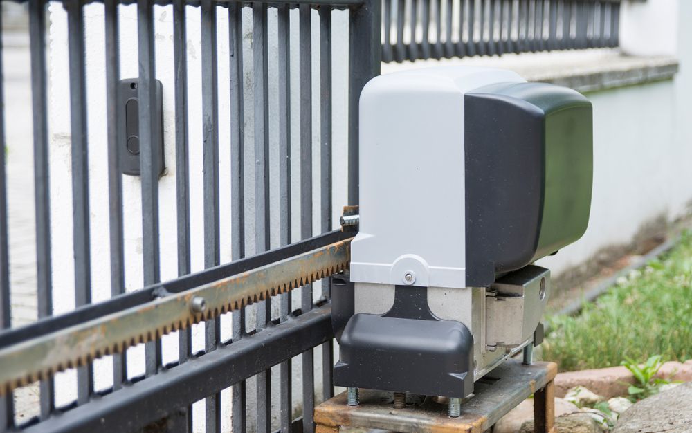 Automatic Gate Opener on a Black Metal Fence — Industry Fire Services in Bowen, QLD