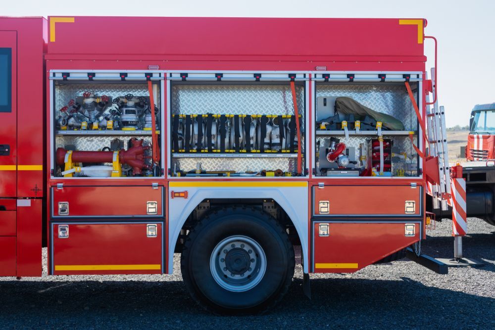 Red Fire Truck With Open Compartments Displaying Equipment — Industry Fire Services in Ingham, QLD