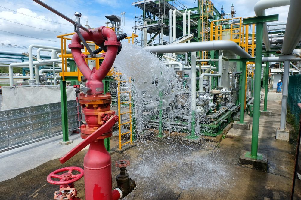 Red Fire Hydrant Spraying Water in an Industrial Setting — Industry Fire Services in Toowoomba, QLD