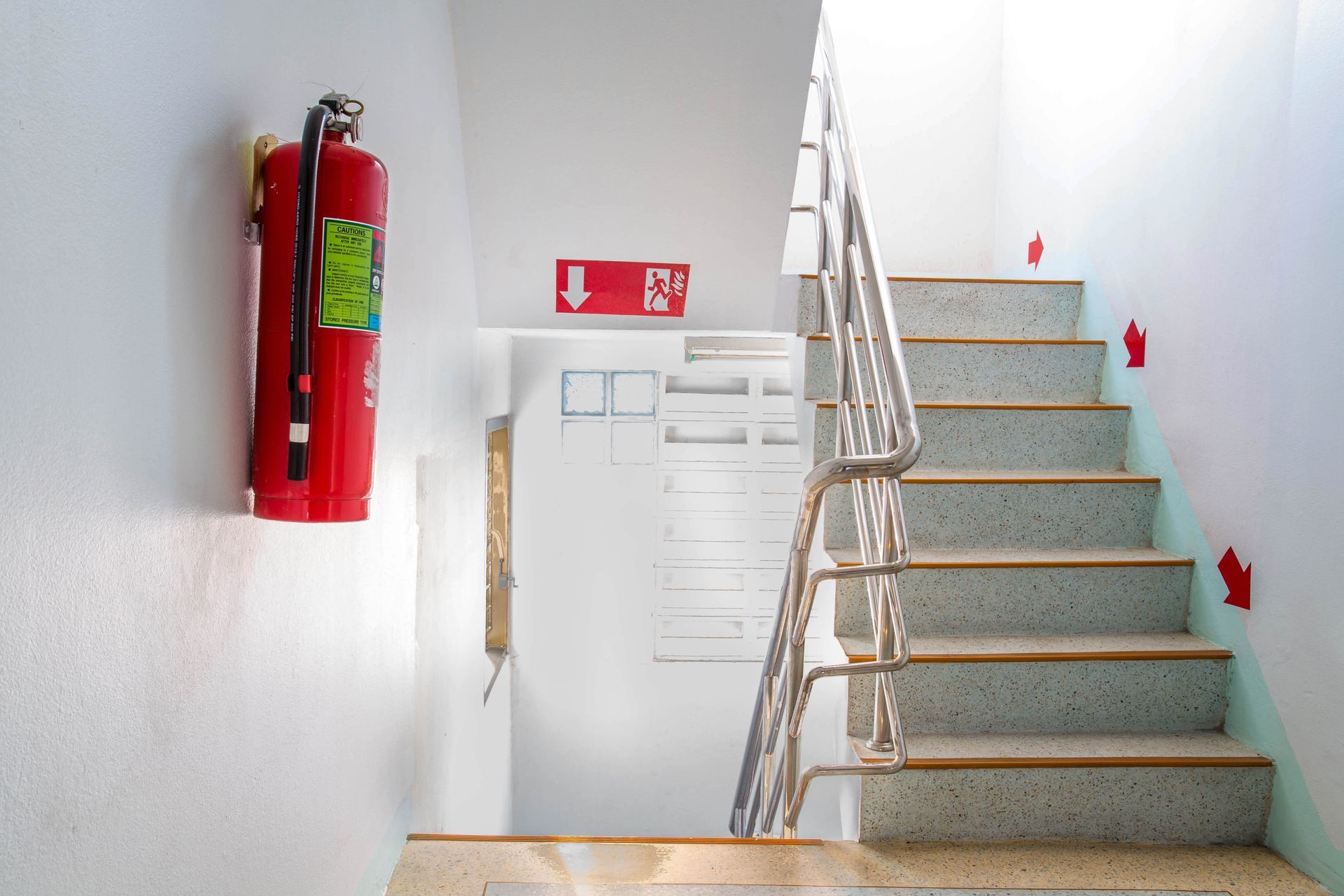 Fire Extinguisher and Stairway in a Building — Industry Fire Services in Mount Isa, QLD