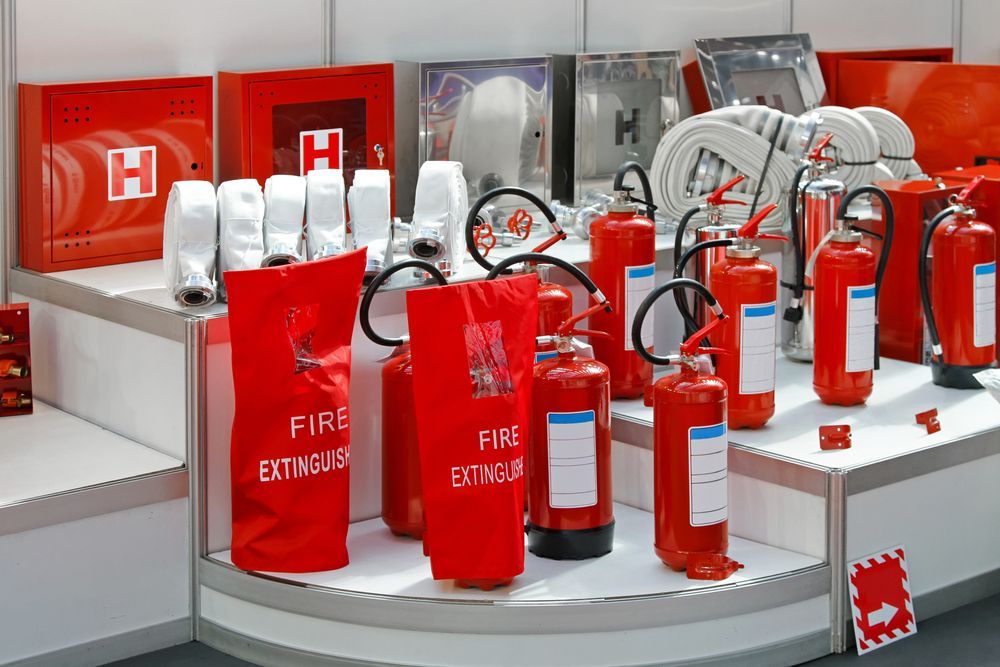 Display of Red Fire Extinguishers and Related Safety Equipment — Industry Fire Services in Ayr, QLD